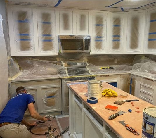 employee working during residential paint job