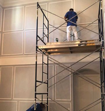 paint contractor painting interior of home