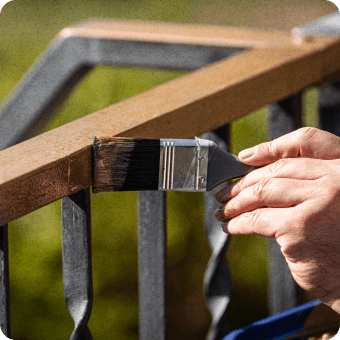 close-up of gentleman painting railing