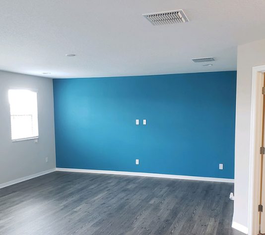 Interior Painting inside bedroom with bright accent wall after painting services