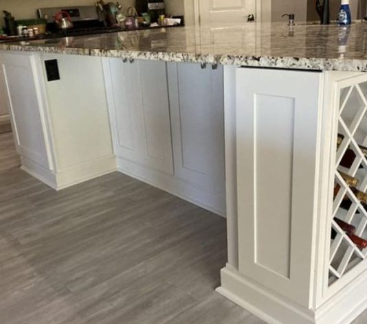 white kitchen cabinet and wine rack refinished