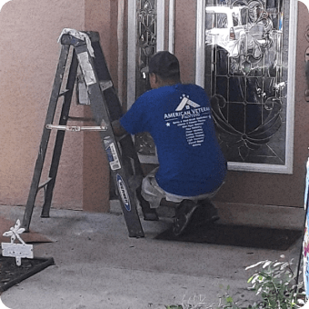 gentleman painting window trim on door