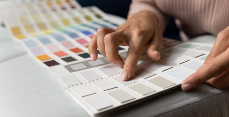a woman choosing a color for her commercial space